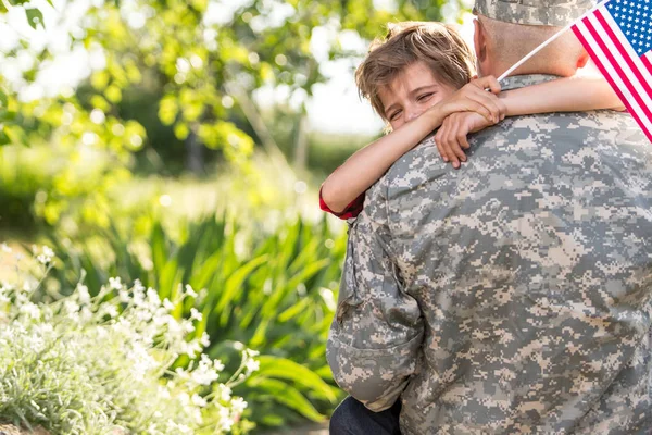 Glückliches Wiedersehen des Soldaten mit der Familie, Sohn umarmt seinen Vater — Stockfoto