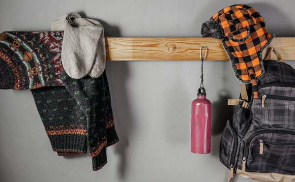 Travel accessories set on wooden shelf and gray background for your text.