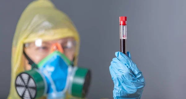 scientist working in laboratory. Medical worker in protection clothes, mask, glasses, gloves with blood sample. Coronavirus outbreaking. Epidemic virus respiratory syndrome