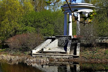 Bahar parkında, ağaçlar ve çalılar yeşile döndü, suda ördekler ve martılar belirdi, kargalar ve serçeler yeşil çimlerde, sincaplar ağaçlarda, park yapıları, rotundalar ve köprüler güneşte parlak görünüyor