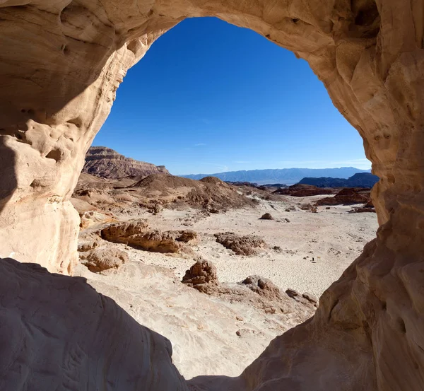 Desert landscape, Mountains and dry land with blue skyline in the background.