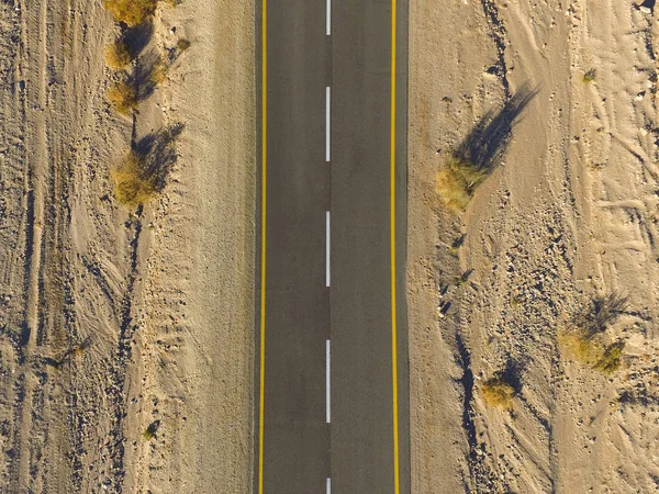 Desert road, Aerial image of a two lane road surrounded by dry desert landscape
