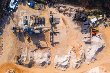 Aerial view of a large Quarry during work hours with Stone sorting conveyor belts.