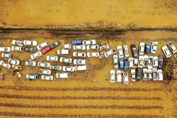 Salvage Car lot in a flooded field, Top down aerial view.