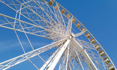 Big wheel with blue sky in the background 