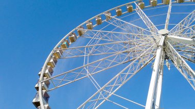 Big wheel with blue sky in the background 