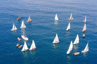 Large group of Sail boats in different sizes at sea, Aerial image.
