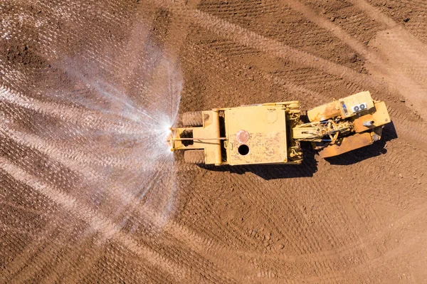 Articulated Water Truck spraying water, Aerial image. — 스톡 사진