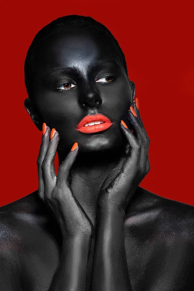 girl with black skin and red lips on a red background