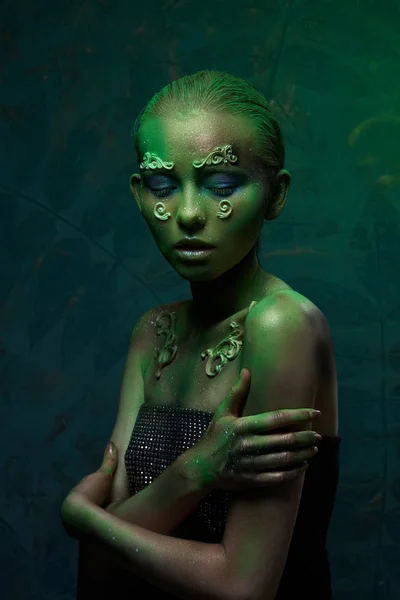 Chica con maquillaje verde creativo en la imagen de un espíritu del bosque — Foto de Stock