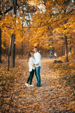 Güz parkında birlikte duran mutlu genç çift.