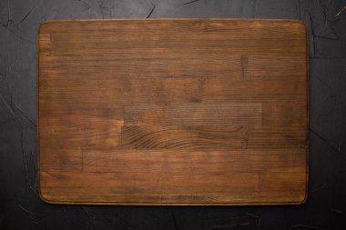 Siyah arkaplanda tahta kesme tahtasının yakın plan görüntüsü