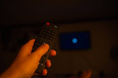 TV uzaktan kumanda tutan erkek el. Bakış açısı vurdu