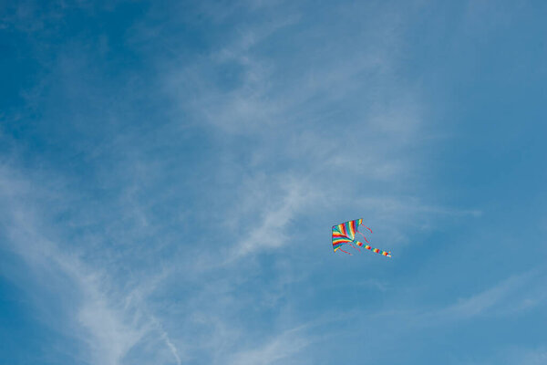 low angle view of colorful kite flying in blue sky