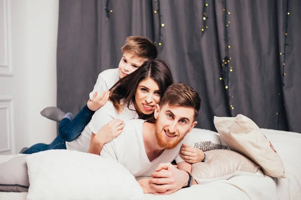 Feliz Joven Padres Con Adorable Pequeño Hijo Acostado Juntos Cama — Foto de Stock