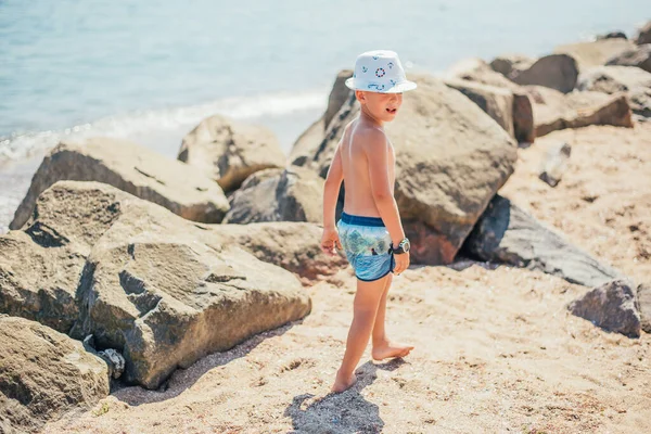 Criança Adorável Shorts Chapéu Andando Praia Areia Com Pedras — Fotografia de Stock