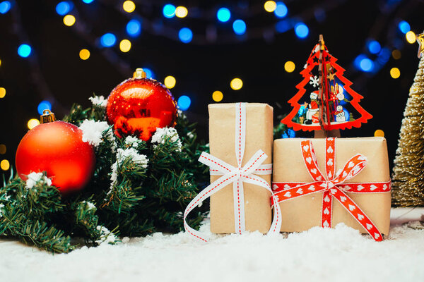 festive christmas background with gift boxes, fir twigs and red baubles 