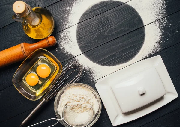 Baking ingredients for homemade pastry on wooden background