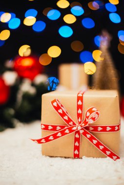 Noel arkaplanı, hediye kutusu, köknar dalları ve kırmızı takılar.