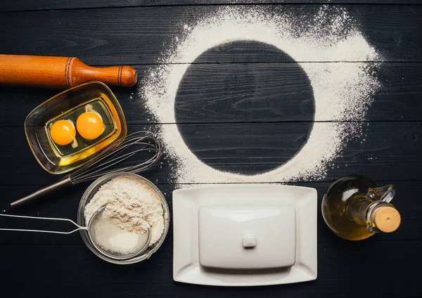 Baking ingredients for homemade pastry on wooden background