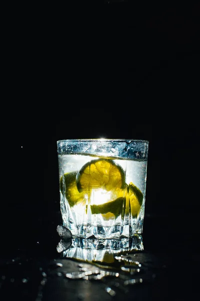 近景玻璃与美味的冷柠檬水与黑色背景 — 图库照片