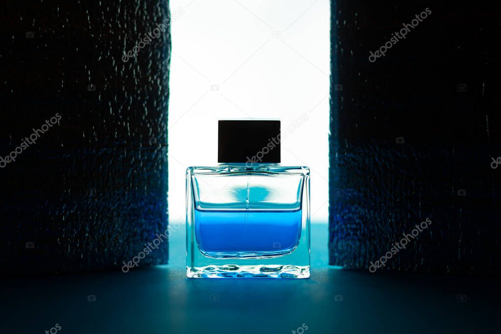 Close-up view of blue bottle of male perfume, cosmetics concept