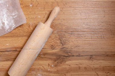 top view of rolling pin and flour on wooden table