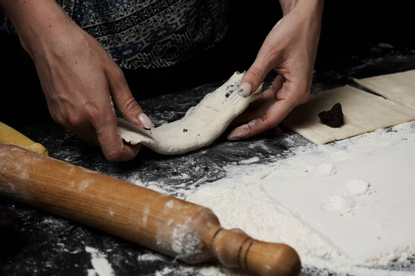 cropped shot of woman cooking sweet buns with poppy seed filling