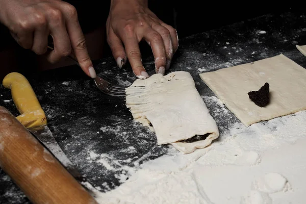 partial view of woman cooking sweet buns with poppy seed filling