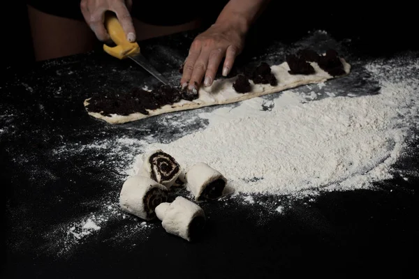 cropped shot of woman cooking sweet buns with poppy seeds