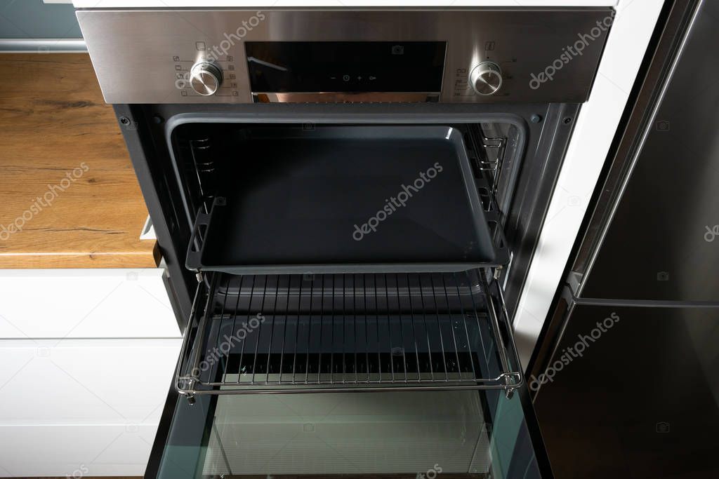 high angle view of open electric oven in modern kitchen