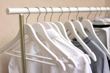 close-up view of stylish clothes on hangers indoors