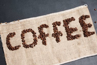Kahve sözcüğünün üst görüntüsü çuvaldaki kahve çekirdeklerinden yapılmış.