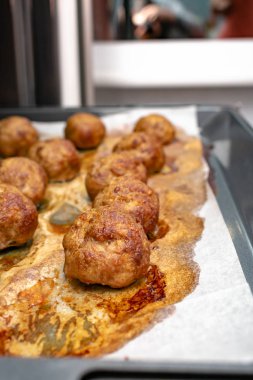 close-up view of delicious cooked meatballs on baking tray 