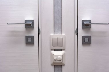 close-up view of modern white doors with metal handles indoors