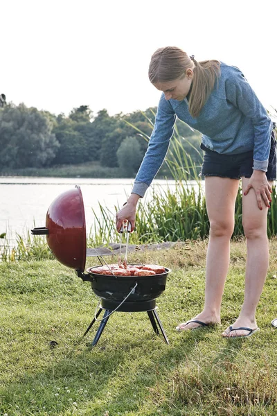 Young Woman Cooking Delicious Meat Charcoal Grill Outdoors — 스톡 사진