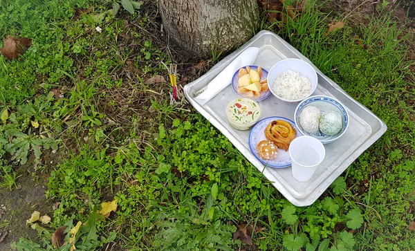 Offerings to wandering souls, foods, water incense sticks. Asian tradition