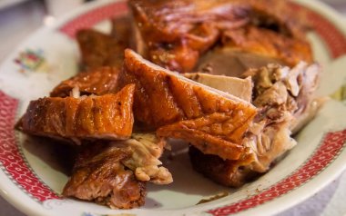 Closeup on peking roast duck, with crisp skin, cut into pieces, imperial meal in a restaurant