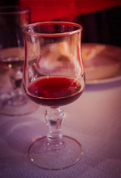 食事中にテーブルの上にボルドーワイングラス 光漏れのスタイル — ストック写真