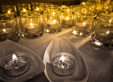 Küçük bardaklarda mumlar ve tekneler dua ve ayin sırasında.