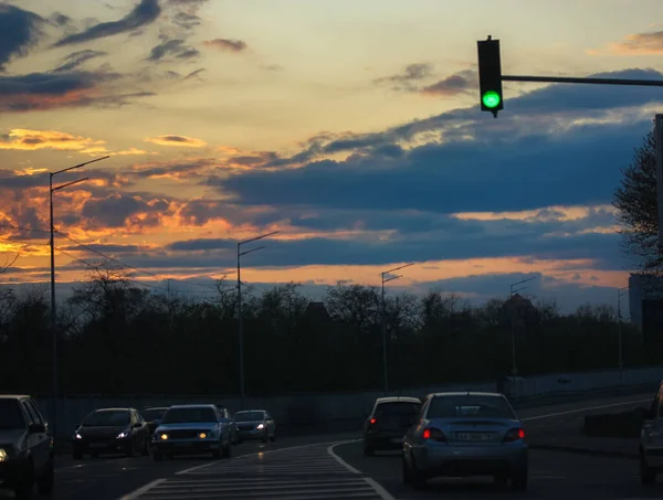 Green traffic light: traffic on the road, urban life.