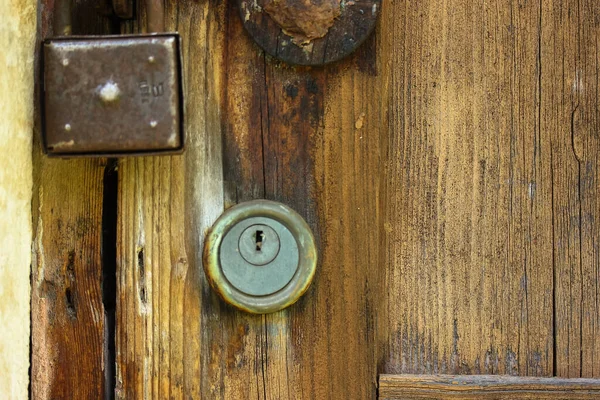 Antique textured door and rusty lock: no access to private property.