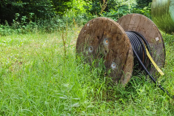 Industrial cable reel on a meadow