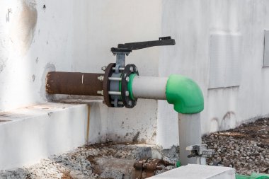 Gray old valve and old green water pipe clipart