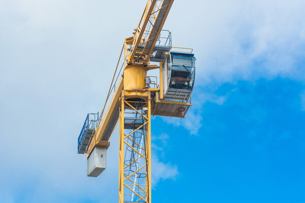 Part of a construction crane against blue sky photographed, space for labeling.