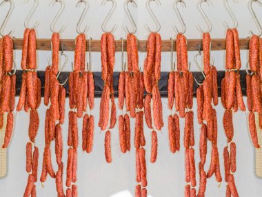 Smoked sausage in butcher's shop                        clipart