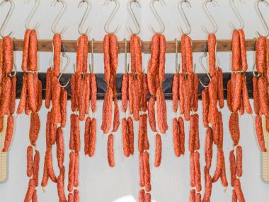 Smoked sausage in butcher's shop                        clipart