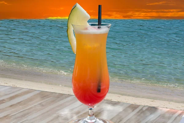 Cocktail Tequila sunrise blauwe zee op de achtergrond. — Stockfoto