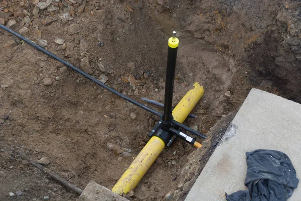 Two plastic pipes in a sand ditch. — Stock Photo, Image