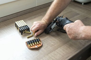 Man reloading an ammunition revolver clipart